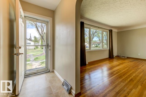 Entryway featuring tile flooring and a white front door with an integrated screen door - 8511 64 Avenue, Edmonton, AB - Indoor Photo Showing Other Room
