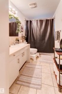 White vanity with chrome hardware, an integrated sink, and a mirrored medicine cabinet - 