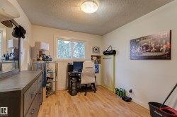Room with wood-finish flooring, a double-pane window, and neutral wall paint - 