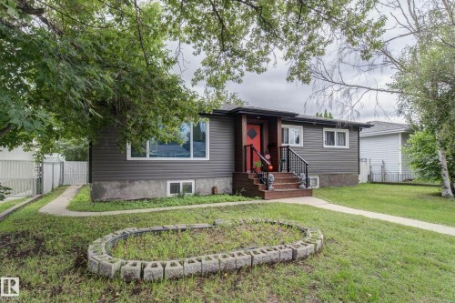 Gray siding exterior with a red front door, white window frames, and black porch railings - 13211 77 Street Nw, Edmonton, AB - Outdoor