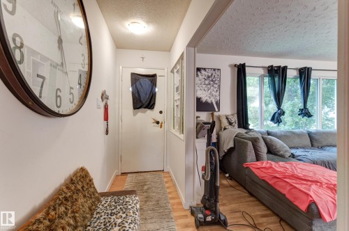 Entryway with wood-finish flooring and a flush-mount ceiling light - 13211 77 Street Nw, Edmonton, AB - Indoor Photo Showing Other Room