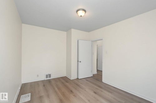 Neutral wall tones and wood-finish flooring define this interior space - 11147 78 Avenue Nw, Edmonton, AB 