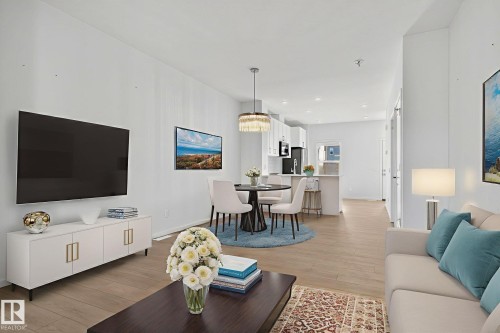 Open-concept living area featuring wood-finish flooring, recessed lighting, and crisp white walls - 264 Orchards Boulevard Sw, Edmonton, AB - Indoor Photo Showing Living Room