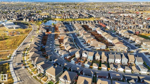 Extensive residential development with a variety of single-family homes, a central water feature, and paved roadways - 264 Orchards Boulevard Sw, Edmonton, AB - Outdoor With View