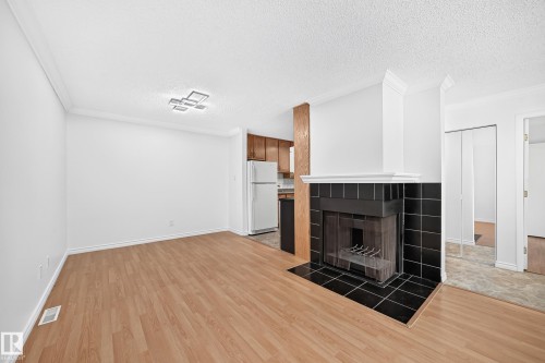 #40 3111 142 Av Nw, Edmonton, AB - Indoor Photo Showing Other Room With Fireplace