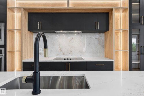 Kitchen island featuring a stainless steel sink with a matte black faucet - 431 172 Avenue, Edmonton, AB - Indoor Photo Showing Kitchen With Upgraded Kitchen