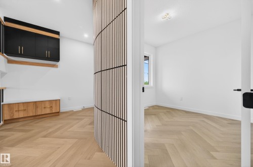 Herringbone wood-finish flooring extending throughout - 431 172 Avenue, Edmonton, AB - Indoor Photo Showing Other Room