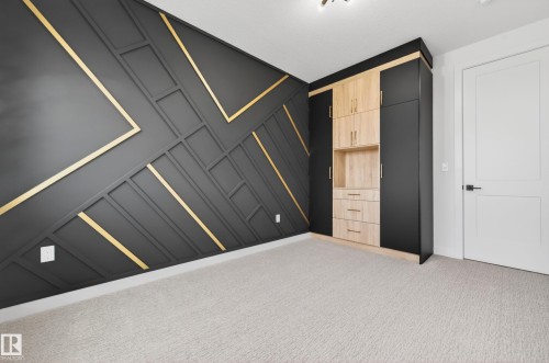 Accent wall featuring geometric paneling with gold trim - 431 172 Avenue, Edmonton, AB - Indoor Photo Showing Other Room