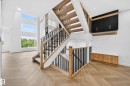 Two-story staircase featuring wood newel posts, black metal balusters, and carpeted treads - 431 172 Avenue, Edmonton, AB  - Indoor Photo Showing Other Room 