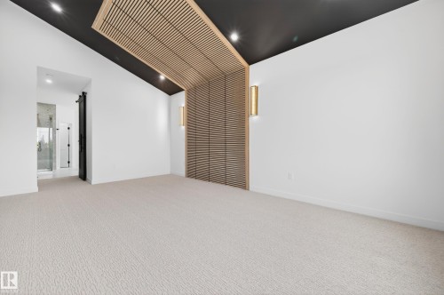 Vaulted ceiling with accent wood slat detailing and integrated lighting - 431 172 Avenue, Edmonton, AB - Indoor Photo Showing Other Room