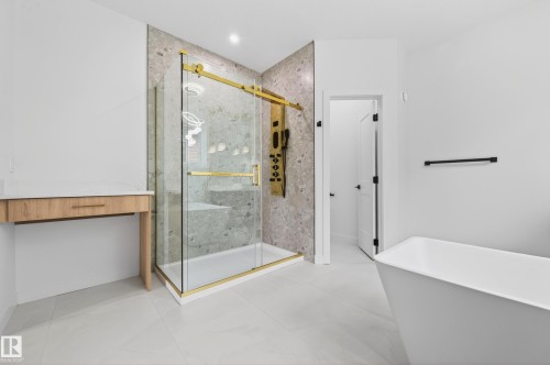 Spacious bathroom featuring a glass-enclosed shower with gold-tone hardware, a textured accent wall, and a built-in shower bench - 431 172 Avenue, Edmonton, AB - Indoor Photo Showing Other Room