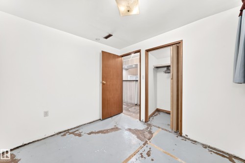 White walls with an exposed concrete floor - 10819 137 Avenue Nw, Edmonton, AB - Indoor Photo Showing Other Room