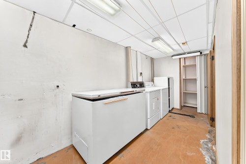 Utility area featuring a chest freezer, washer, and dryer - 10819 137 Avenue Nw, Edmonton, AB - Indoor Photo Showing Laundry Room