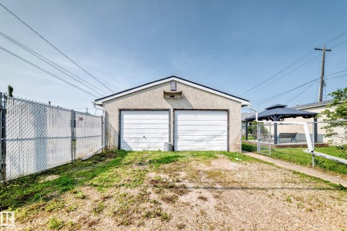 Detached two-car garage with stucco exterior and white garage doors - 10819 137 Avenue Nw, Edmonton, AB - Outdoor With Exterior
