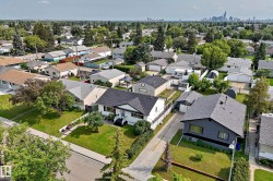 Aerial neighborhood overview showcasing residential properties and lush green landscaping - 