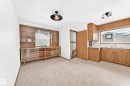 Kitchen and dining area featuring wood cabinetry, white countertops, and a double basin sink - 10819 137 Avenue Nw, Edmonton, AB  - Indoor 