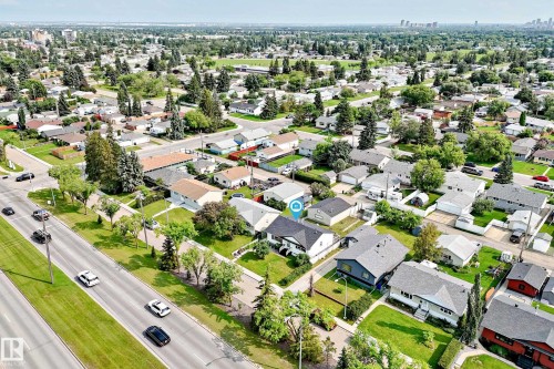 Residential neighborhood with a mix of single-family homes, mature trees, and paved streets - 10819 137 Avenue Nw, Edmonton, AB - Outdoor With View