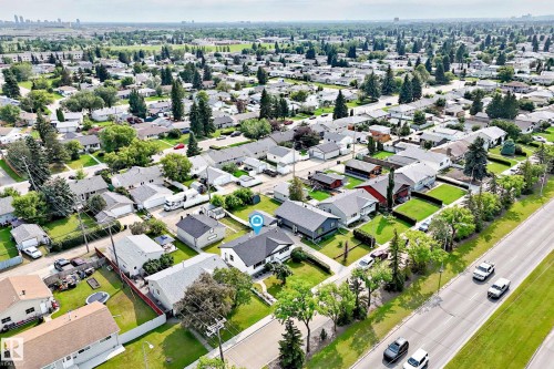 Aerial perspective of a residential neighborhood featuring detached single-story homes with pitched roofs, front yards, and mature trees - 10819 137 Avenue Nw, Edmonton, AB - Outdoor With View