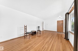 Hardwood flooring extends throughout this expansive room - 