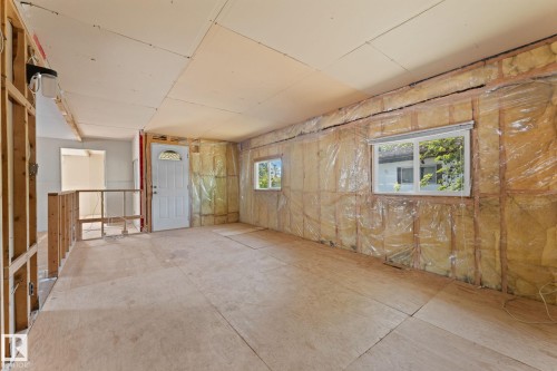 Open floor plan featuring plywood subflooring, multiple windows, and partial drywall installation - 219 Lee Ridge Road, Edmonton, AB - Indoor Photo Showing Other Room