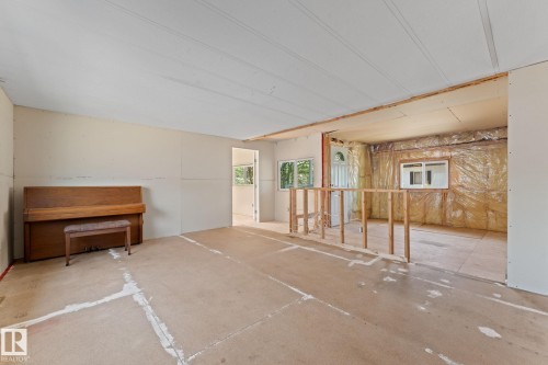 Interior space presenting a renovation opportunity with exposed framing, partial drywall installation, and visible insulation - 219 Lee Ridge Road, Edmonton, AB - Indoor Photo Showing Other Room