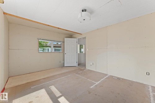 Room featuring drywall installation, a white paneled door, a single window, and a flush-mount ceiling light fixture - 219 Lee Ridge Road, Edmonton, AB - Indoor Photo Showing Other Room