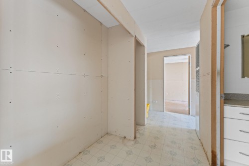 Interior space mid-renovation with exposed drywall, visible framing, and patterned vinyl flooring - 219 Lee Ridge Road, Edmonton, AB - Indoor Photo Showing Other Room