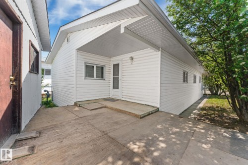 Covered entry featuring white vinyl siding and a concrete pad - 219 Lee Ridge Road, Edmonton, AB - Outdoor With Exterior