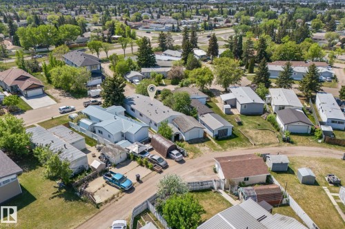 Aerial perspective of a neighborhood featuring multiple detached single-story residences with pitched roofs and various outbuildings - 219 Lee Ridge Road, Edmonton, AB - Outdoor With View