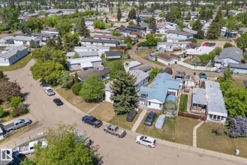 Single-story residence with a light blue metal roof, white siding, and a front porch - 219 Lee Ridge Road, Edmonton, AB - Outdoor With View
