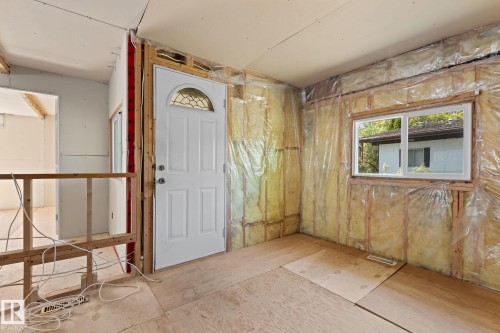 Entryway featuring a white paneled door with an arched stained-glass insert - 219 Lee Ridge Road, Edmonton, AB - Indoor Photo Showing Other Room
