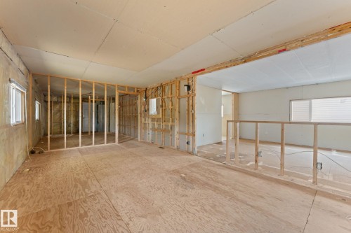 Interior space featuring exposed wood framing and subflooring, multiple windows, and partial drywall installation - 219 Lee Ridge Road, Edmonton, AB - Indoor Photo Showing Other Room