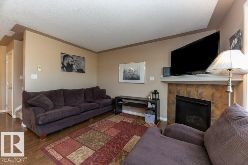 #134 5420 Grant Macewan Bv, Leduc, AB - Indoor Photo Showing Living Room With Fireplace