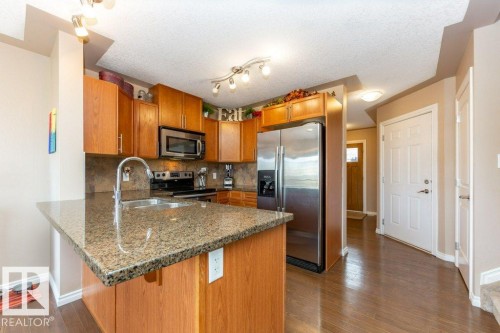 #134 5420 Grant Macewan Bv, Leduc, AB - Indoor Photo Showing Kitchen With Double Sink