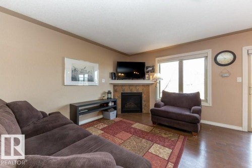 #134 5420 Grant Macewan Bv, Leduc, AB - Indoor Photo Showing Living Room With Fireplace