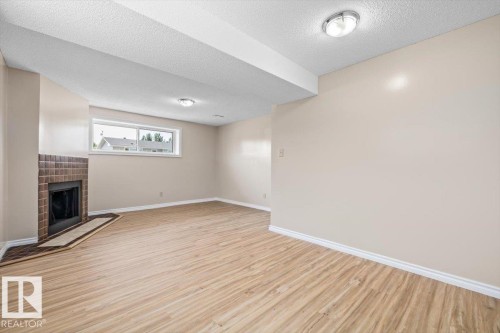 5212 50 Avenue, Bruderheim, AB - Indoor Photo Showing Other Room With Fireplace
