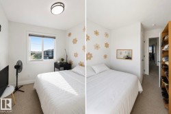 Bedroom featuring neutral carpeting, a large window, a ceiling-mounted light fixture, and a built-in open shelving unit - 