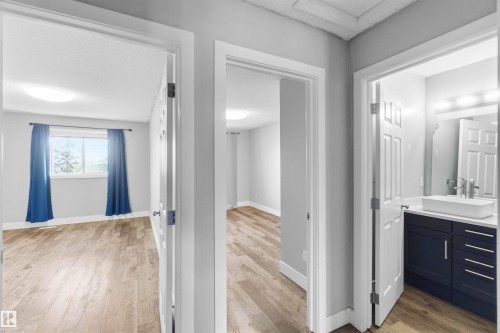 Hallway presenting three separate doorways - #64 120 Magrath Rd Nw, Edmonton, AB - Indoor
