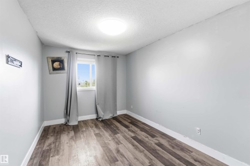 Light grey walls with white trim, wood-finish flooring, and a single window - #64 120 Magrath Rd Nw, Edmonton, AB - Indoor Photo Showing Other Room