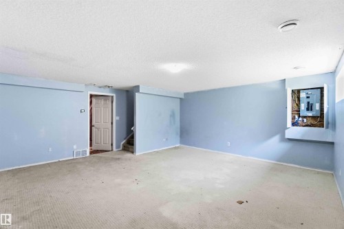 Expansive room featuring light blue walls and a neutral carpet - #64 120 Magrath Rd Nw, Edmonton, AB - Indoor Photo Showing Other Room