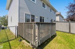 Outdoor deck with a wood railing and a sliding glass door entry to the home - 