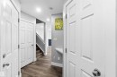 Hallway featuring wood-finish flooring, white paneled doors, and recessed lighting - #64 120 Magrath Rd Nw, Edmonton, AB  - Indoor Photo Showing Other Room 