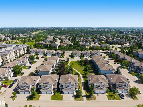Aerial perspective showcasing a residential development with multiple detached and attached homes - #64 120 Magrath Rd Nw, Edmonton, AB - Outdoor With View