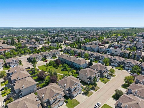 Expansive residential development featuring mature landscaping, paved streets, and varied architectural styles - #64 120 Magrath Rd Nw, Edmonton, AB - Outdoor With View