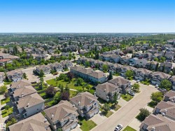Expansive residential development featuring mature landscaping, paved streets, and varied architectural styles - 