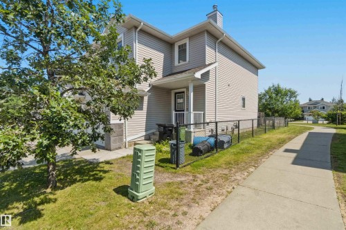 Two-story residence featuring light gray siding and stone accents - #64 120 Magrath Rd Nw, Edmonton, AB - Outdoor