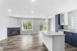 Open-concept living space with wood-finish flooring - 