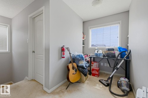 Interior space featuring light gray walls, white trim, and neutral carpeting - 3724 163 Avenue Nw, Edmonton, AB - Indoor Photo Showing Other Room