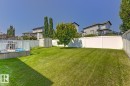 Expansive backyard featuring a manicured lawn, a white privacy fence, and a dedicated storage shed - 3724 163 Avenue Nw, Edmonton, AB  - Outdoor With Backyard 