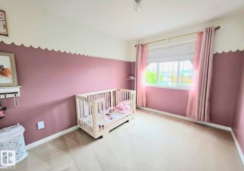 Room featuring carpet flooring and a multi-pane window - 13 Baie Madelene, Beaumont, AB - Indoor Photo Showing Bedroom